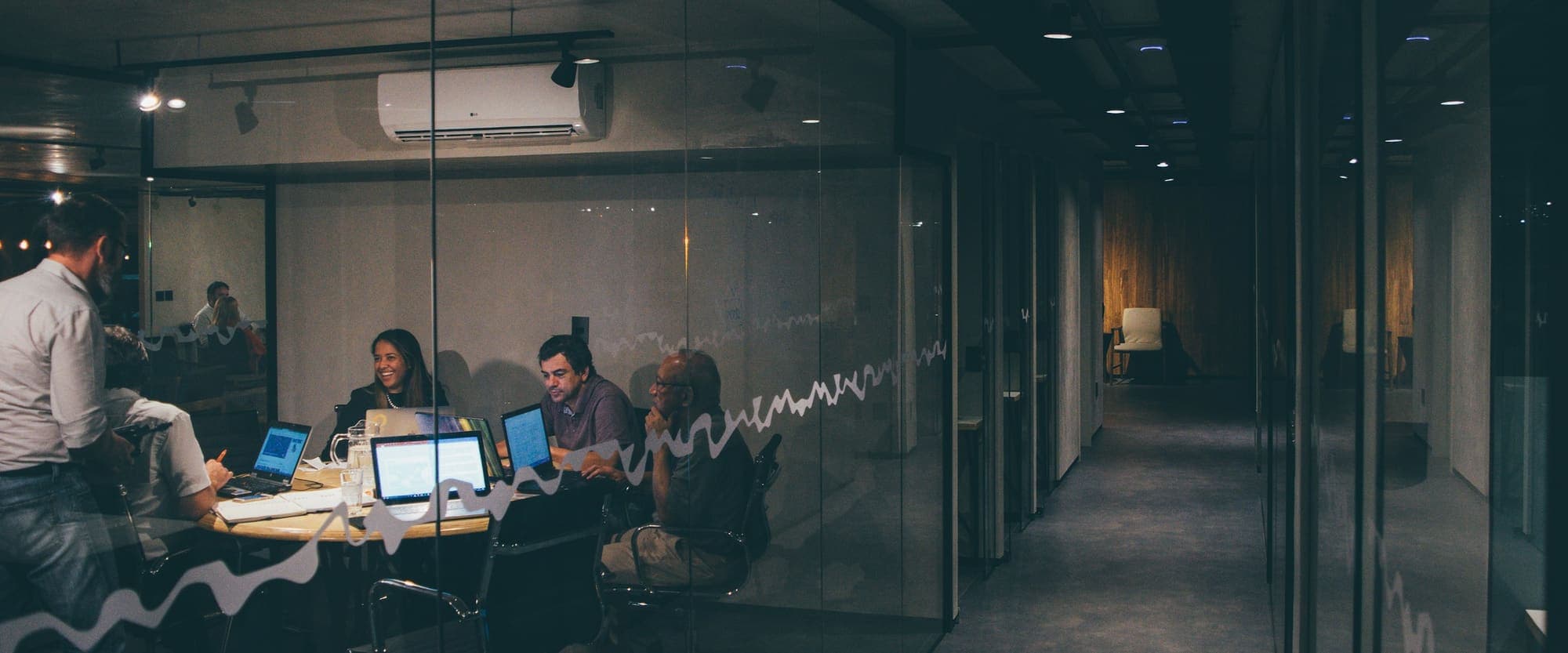 Consultants meeting in a glass-walled office